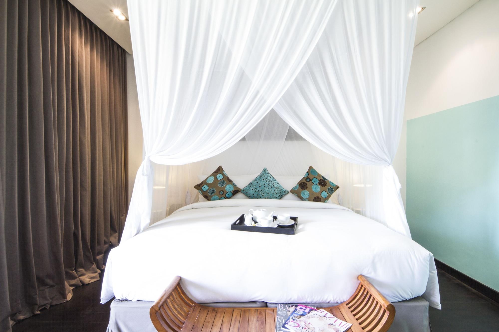 Montigo Resorts Seminyak Bagian luar foto A mosquito net over a bed