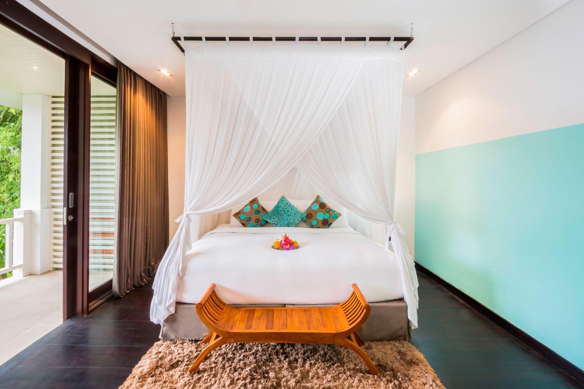 Montigo Resorts Seminyak Bagian luar foto A bed with a mosquito net